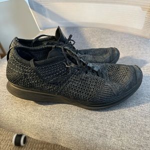 Triple black Nike flyknit racer running sneaker